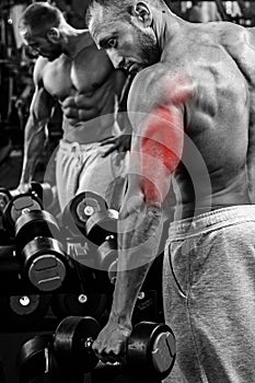 Triceps specialization in bodybuilding. Man during workout in the gym