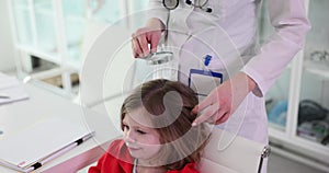 Trichologist examines condition of child girl hair