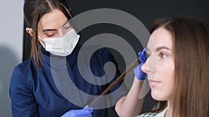 A trichologist in gloves examines the hair. Consultation with a dermatologist.