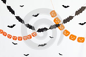 Trick or Treat concept. Holiday composition with halloween garland decorations pumpkins and bats isolated on white
