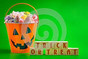 A Trick or Treat SIgn and a Bucket FIlled with Saltwater Taffy Candy