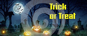 Trick or Treat - A spooky Halloween graveyard with pumpkins, bats, a black cat, full moon and green mist
