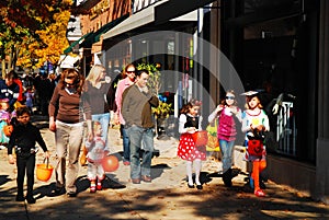 Trick or treaters walk through downtown