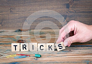 Tricks. Wooden letters on the office desk. Business and communication background