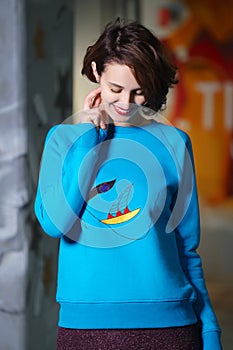 Tricky girl posing in blue fleece sweatshot photo