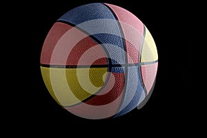 Tricolor basketball black background, isolate.