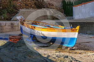 Tricolor boat on the beach of the Tyrrhenian Sea on Elba Island