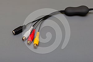 tricolor composite cable with decoder on gray background