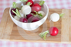 Tricolor radishes in a bowl on a table