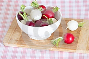 Tricolor radishes in a bowl on a table