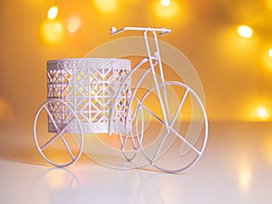 Tricycle with a basket on the background of blurred lights