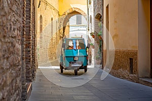 Tricycle driving in an empty street in Spello photo