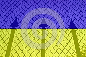 A trident on the background of a chain-link mesh and a blue yellow background of the flag as a symbol of Ukrainian photo