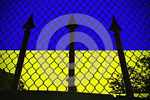 A trident on the background of a chain-link mesh and a blue yellow background of the flag as a symbol of Ukrainian photo
