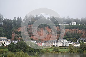 Trier, Germany - 09 26 2023: The red cliffs in the city with morning fog