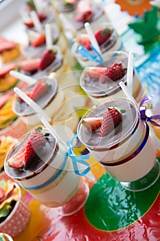 Trifles in cups with chocolate and strawberries