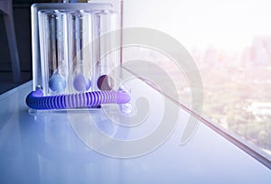 Triflow incentive spirometer on blurred park background.