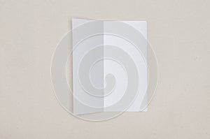 Trifold white template paper on grey background.