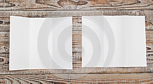 Trifold white template paper on wood texture . photo