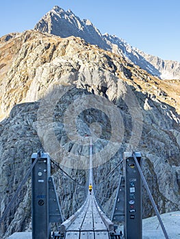 Trift, Switzerland - October 18th 2022: Spectacular rope bridge Triftbruecke crossing a canyon