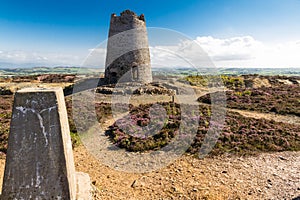 Trig point with derelict windmill, Parys Mountain.