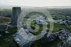 Trig Point Marker overlooking the North Wales Countryside and Ceredigion Bay.