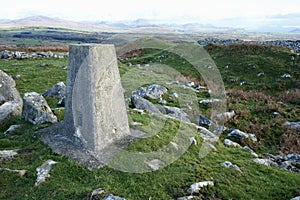 Trig Point Marker overlooking the North Wales Countryside and Ceredigion Bay.