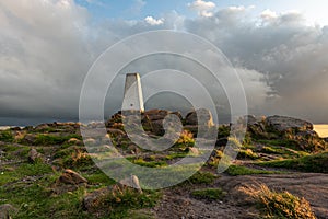 Trig point on top of The Roaches at sunset in the Peak District National Park