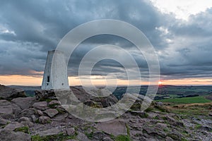 Trig point on top of The Roaches at sunset in the Peak District National Park