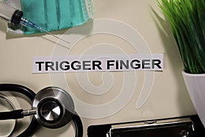 Trigger Finger with inspiration and healthcare/medical concept on desk background