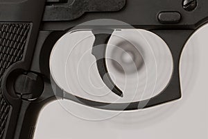 The trigger of a handgun with a shooting target