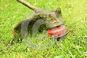 Trimmer close up mow the grass with a lawnmower. Gardening with a brush cutter Close-up. Lawn care with brush cutters