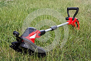 Trimmer on the green lawn in the garden