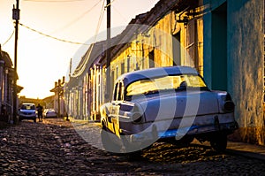 Trinidad, Cuba: Street with oldtimer at sunset