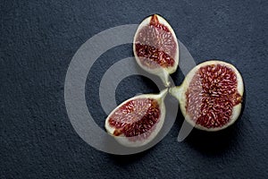 Trinity of chopped fresh figs on black shale