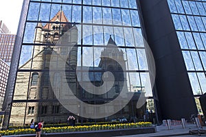 Trinity Church reflecting on John Hancock tower in Copley Square Boston