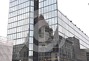 Trinity Church Reflection on a Modern Glass Skyscraper from Boston downtown in Massachusettes State of USA