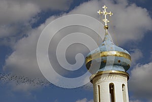 Trinity Sergius Lavra in Russia. Birds fly over a church dome