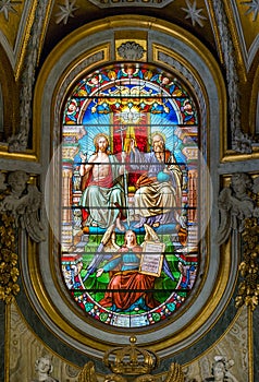 The Trinity in the stained glass of the Church of Santa Maria dell`Anima, in Rome, Italy.