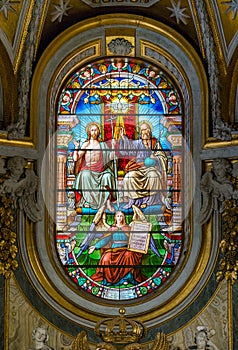 The Trinity in the stained glass of the Church of Santa Maria dell`Anima, in Rome, Italy. photo