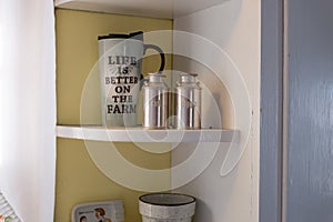 trinkets in old farmhouse proudly on display in kitchen window