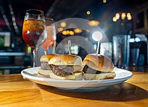A trio of juicy filet mignon sandwiches with tasty cocktails