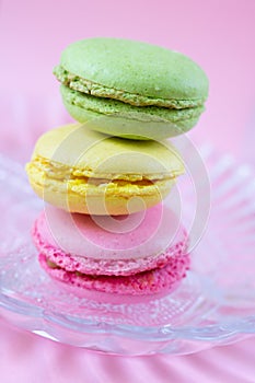 Trio of macarons made of almond flour as stack one on top od ech other on plate. French