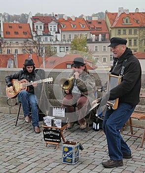 Trio of street musicians. on the Charles bridge in the historical center of old Prague. Czech Republic, Europe, autumn.