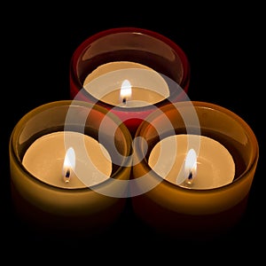 Trio of tea-lights arranged in a triangle