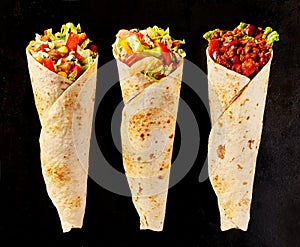 Trio of Tex Mex Fajita Wraps on Black Background