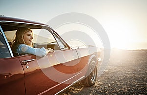 This trip is exactly what I needed. a young woman enjoying a road trip along the coast.