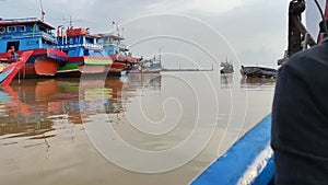 A trip of group of anglers goes to a fishing spots by boat.