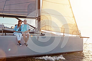 This trip is just what they needed. a couple enjoying a boat cruise out on the ocean.