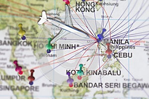 Trip to Manila with toy airplane and push pin on map of The Phi